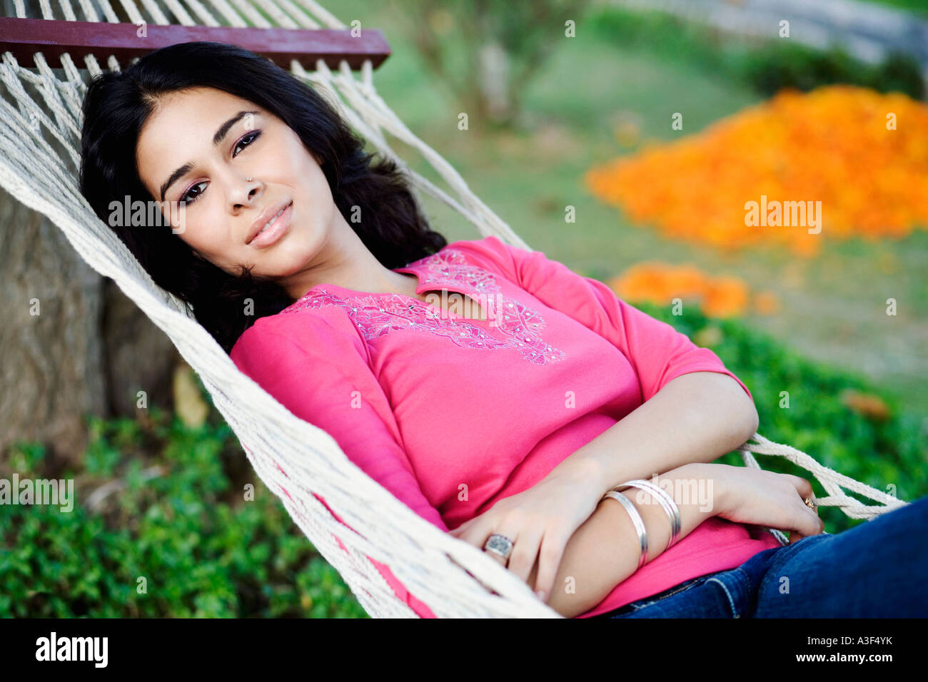 Portrait of a young woman lying in a hammock Stock Photo - Alamy
