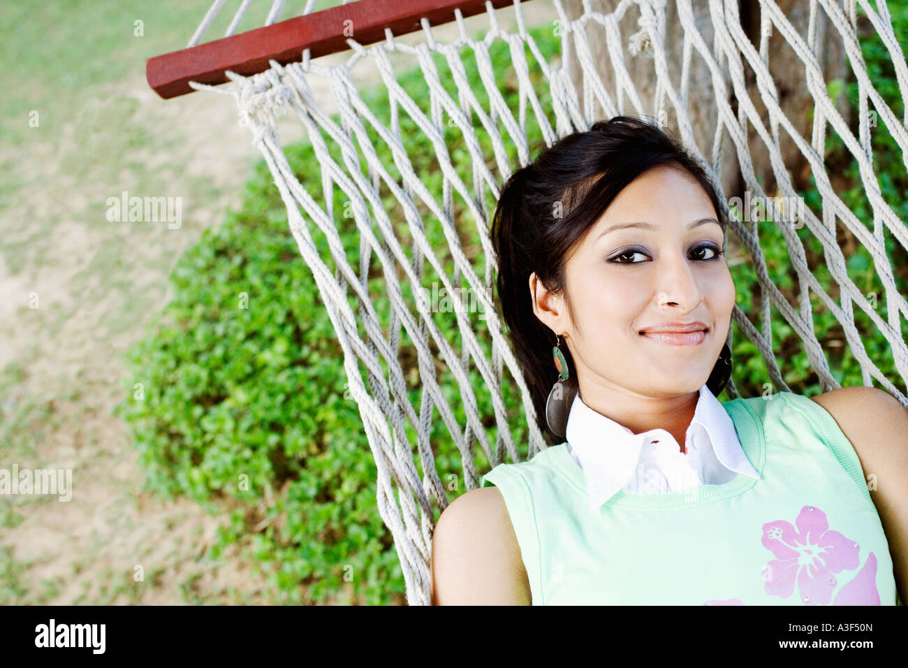 Portrait of a young woman lying in a hammock Stock Photo - Alamy