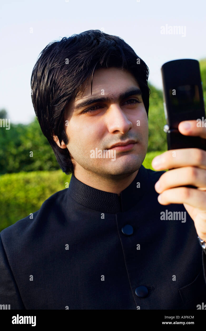 Close-up of a young man using a mobile phone Stock Photo - Alamy
