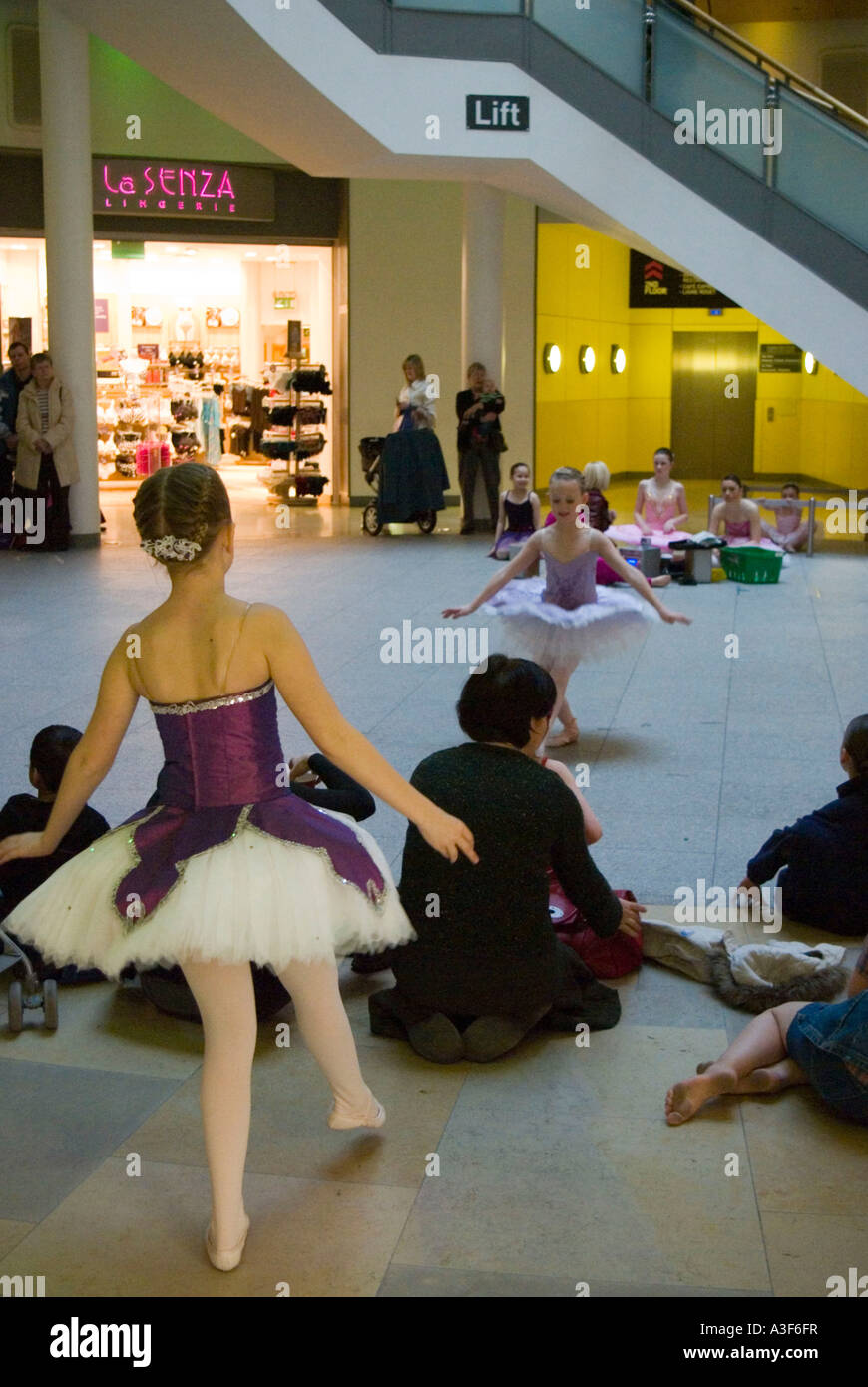 Young ballet school pupils give a public performance in a busy shopping