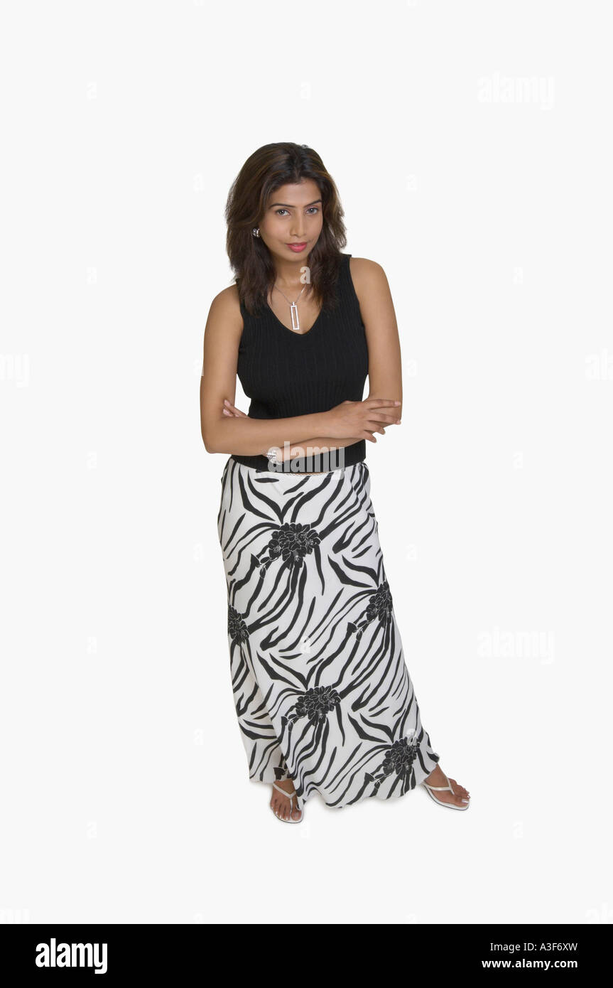 Portrait of a young woman standing with her arms crossed Stock Photo ...