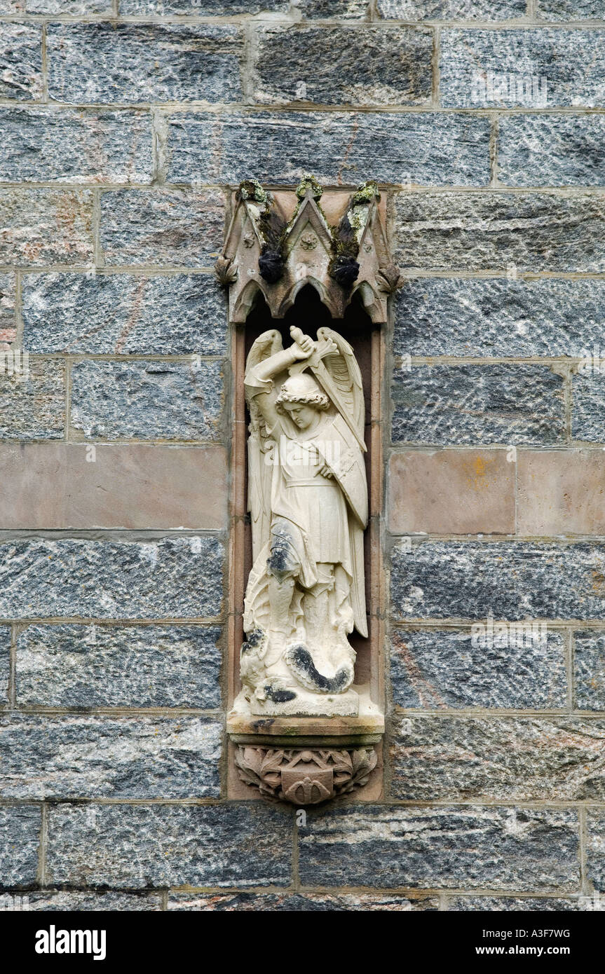 Stone Carving of the Angel Michael Defeating the Serpent on the Exterior of Saint Mary's and Saint Finnan Roman Catholic Church Stock Photo