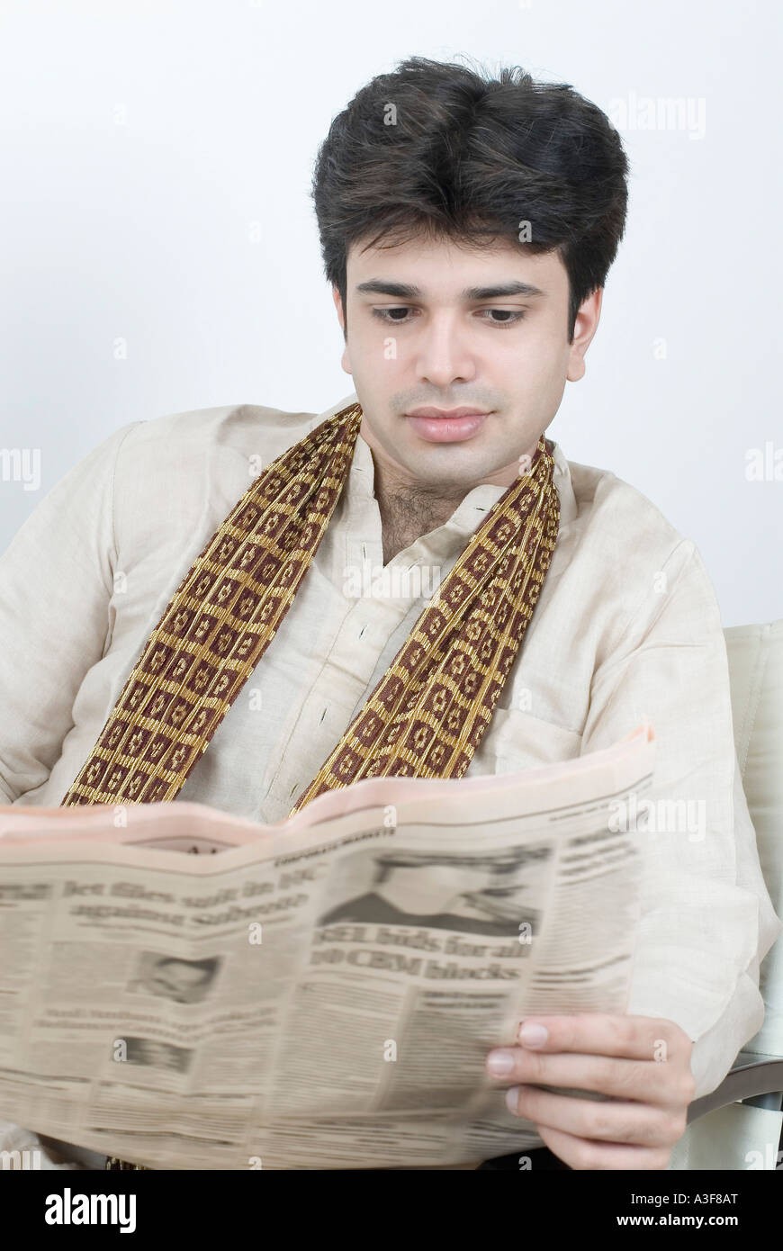Close-up of a young man reading a newspaper Stock Photo - Alamy