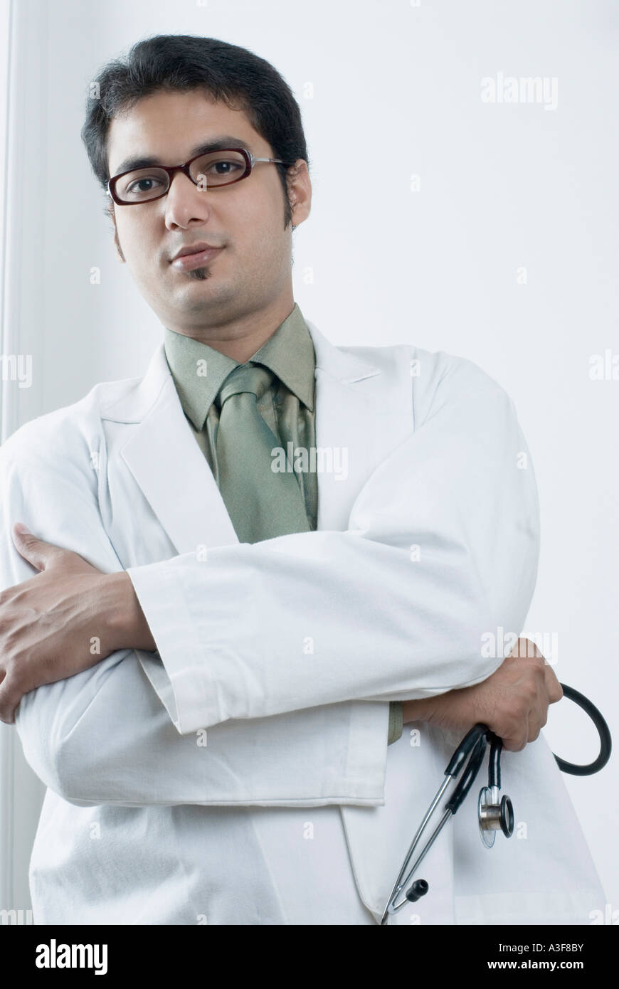 Portrait of a male doctor holding a stethoscope Stock Photo - Alamy