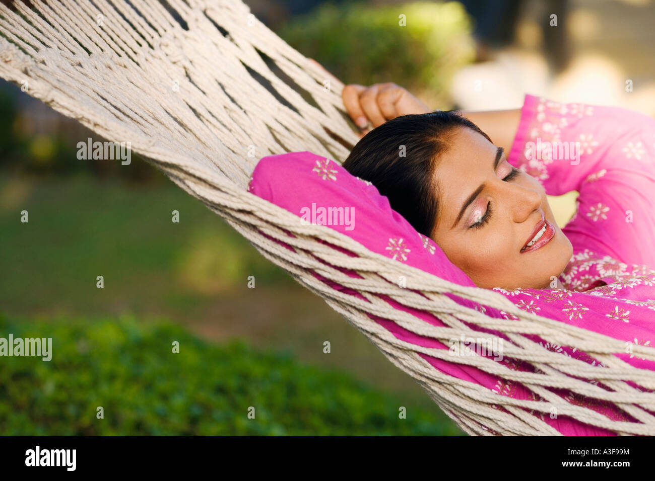 Close-up of a young woman lying in a hammock Stock Photo - Alamy