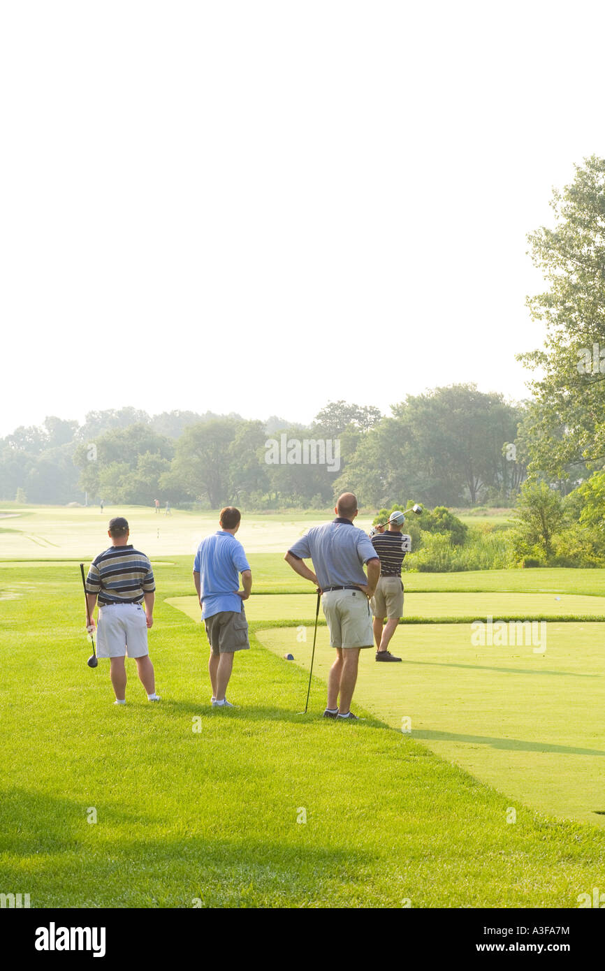 golf foursome on tee Stock Photo - Alamy