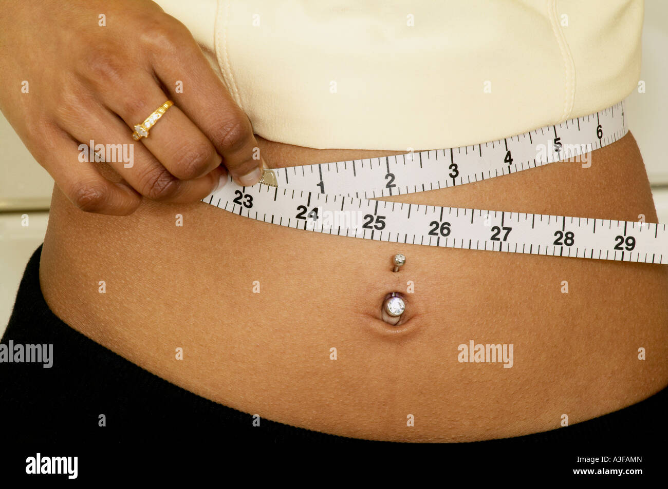 asian woman measuring her tiny 23 inch waist Stock Photo - Alamy