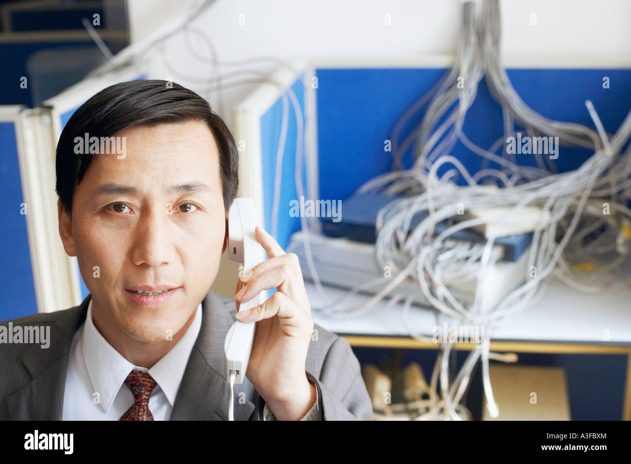 Portrait of a businessman using a telephone in a server room Stock ...