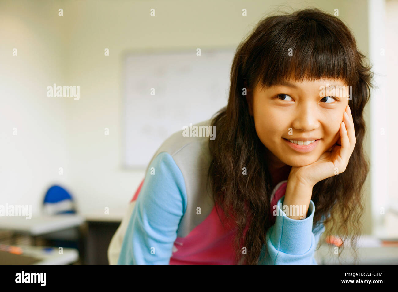 Close-up of a young woman smiling in the classroom Stock Photo - Alamy