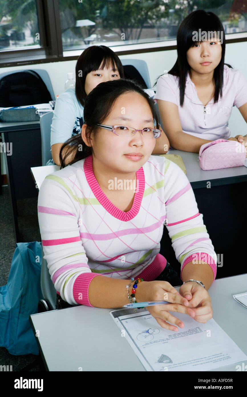 High angle view of three teenage girls sitting in a classroom Stock ...