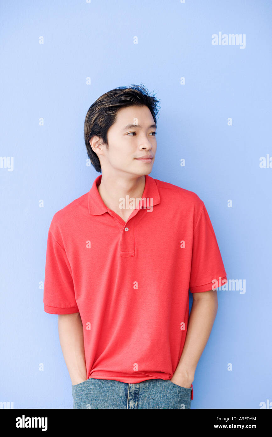 Young man leaning against a wall Stock Photo - Alamy