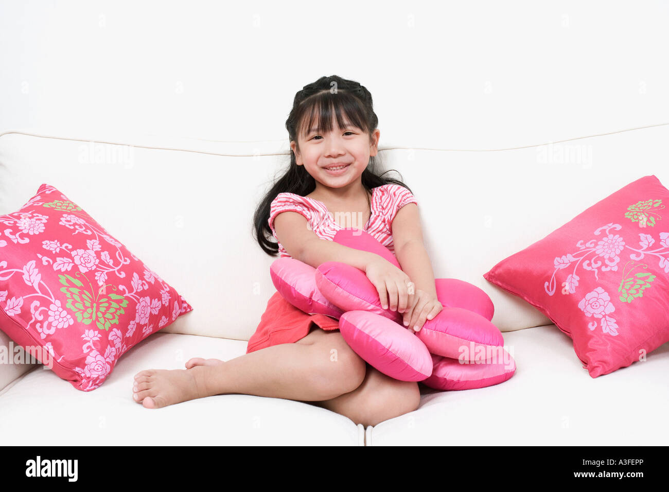 Portrait of a girl sitting on a couch Stock Photo - Alamy