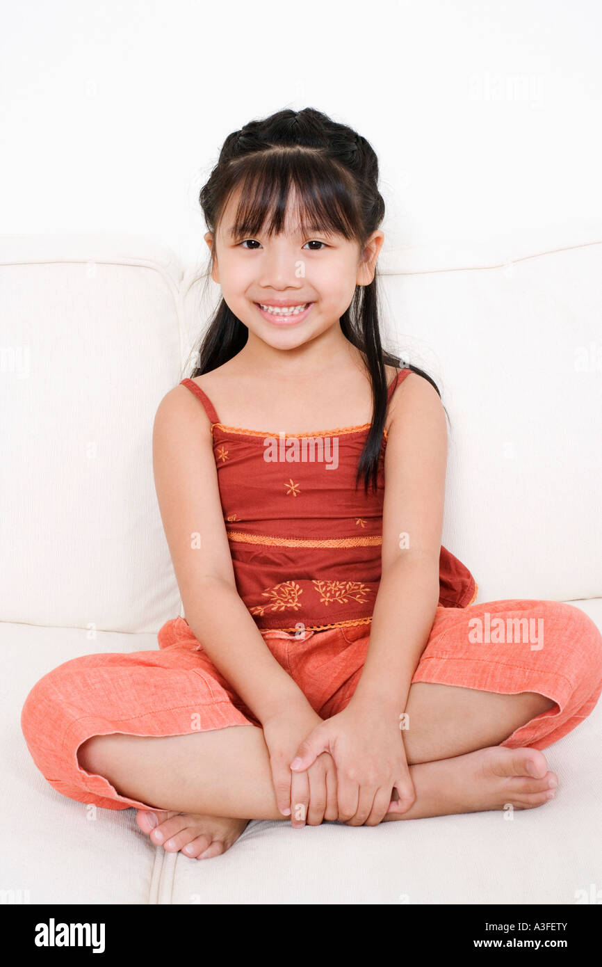 Portrait of a girl sitting on a couch Stock Photo - Alamy