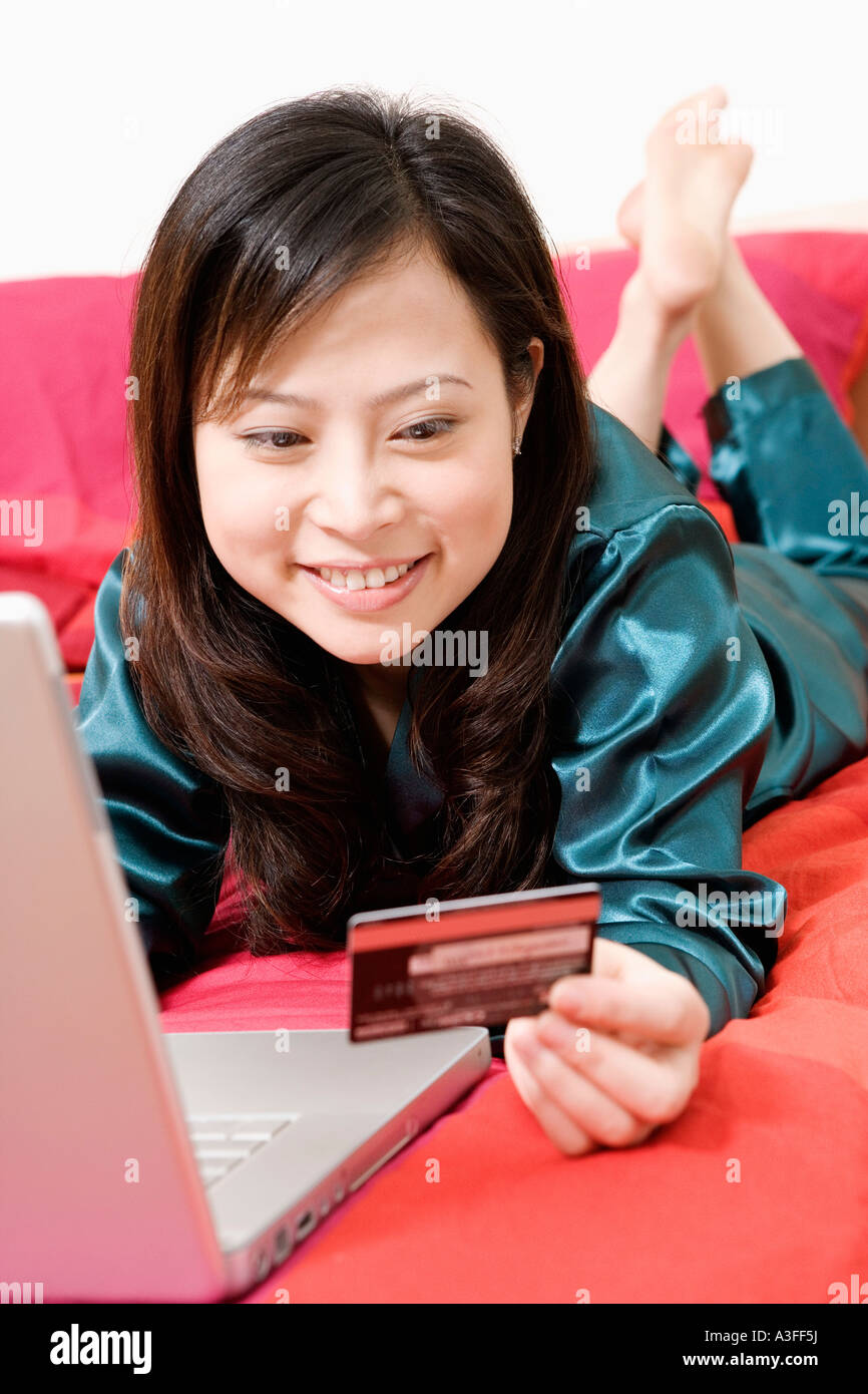 Close-up of a young woman holding a credit card Stock Photo
