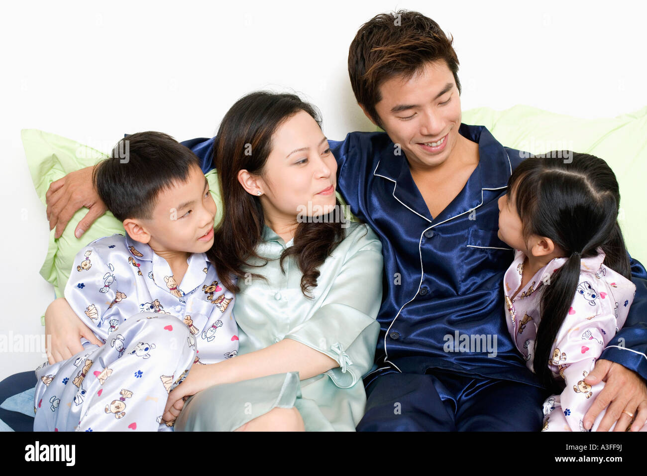 Close-up of a mid adult man and a young woman with their children on ...