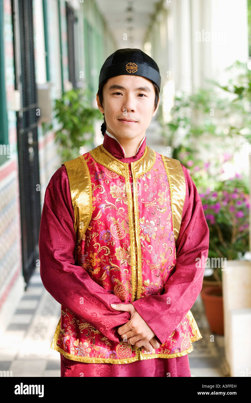 Portrait of a mid adult man in traditional clothing standing in a ...