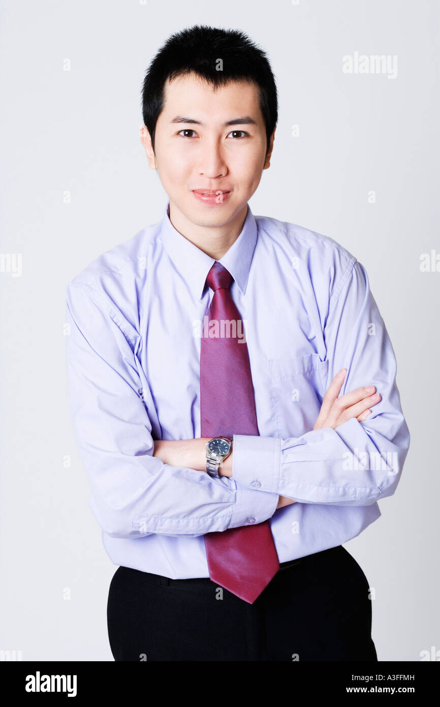 Portrait of a businessman standing with his arms crossed Stock Photo ...