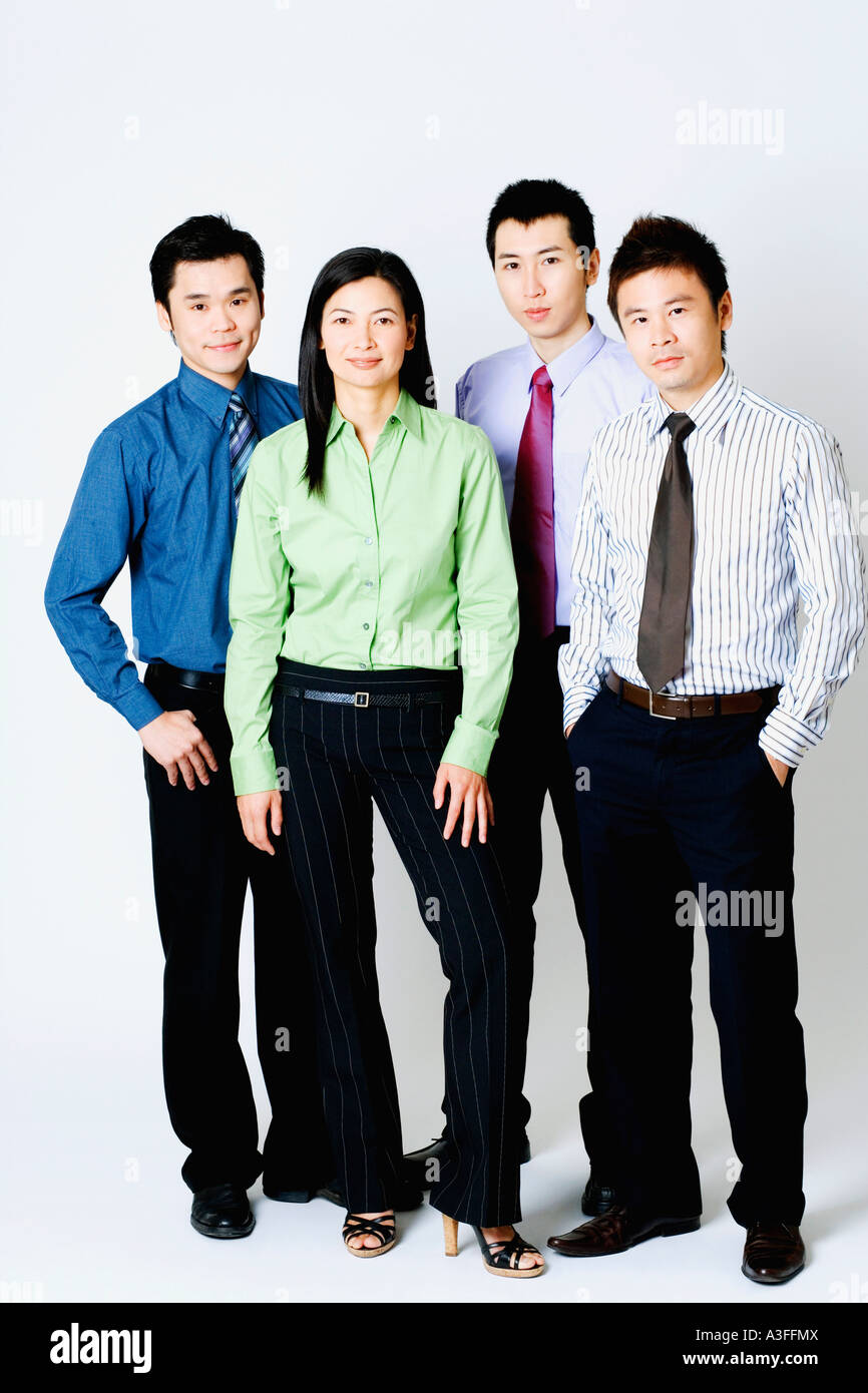 Portrait of three businessmen and a businesswoman standing Stock Photo ...