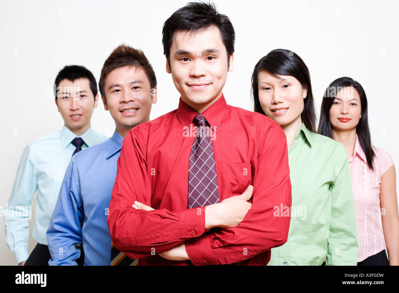 Portrait of five business executives standing together and smiling ...