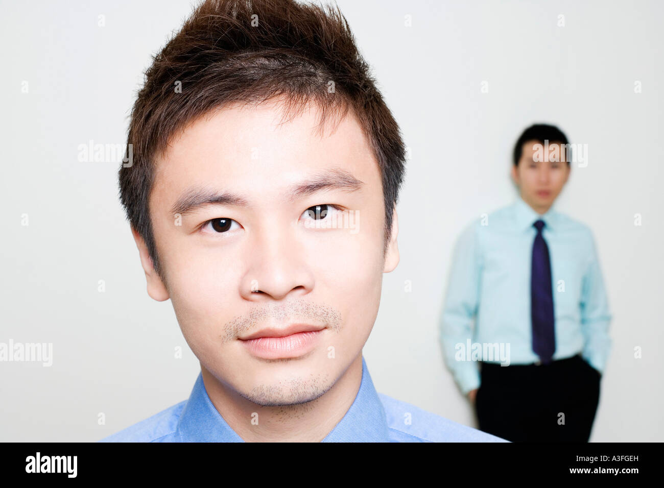 Portrait of a businessman with another standing behind him Stock Photo