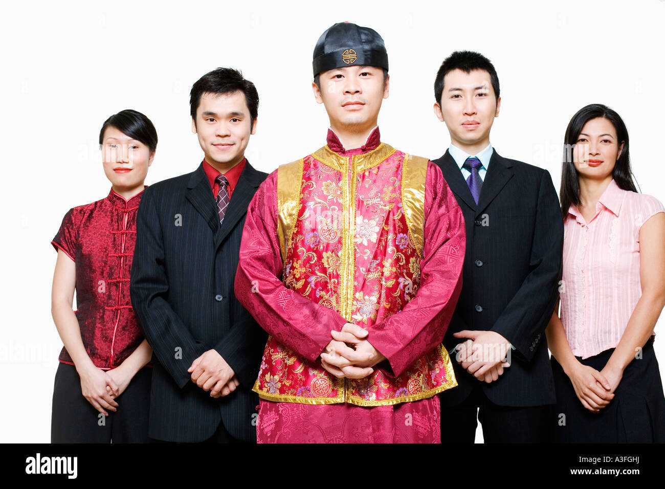 Portrait of four business executives and a young man standing together ...