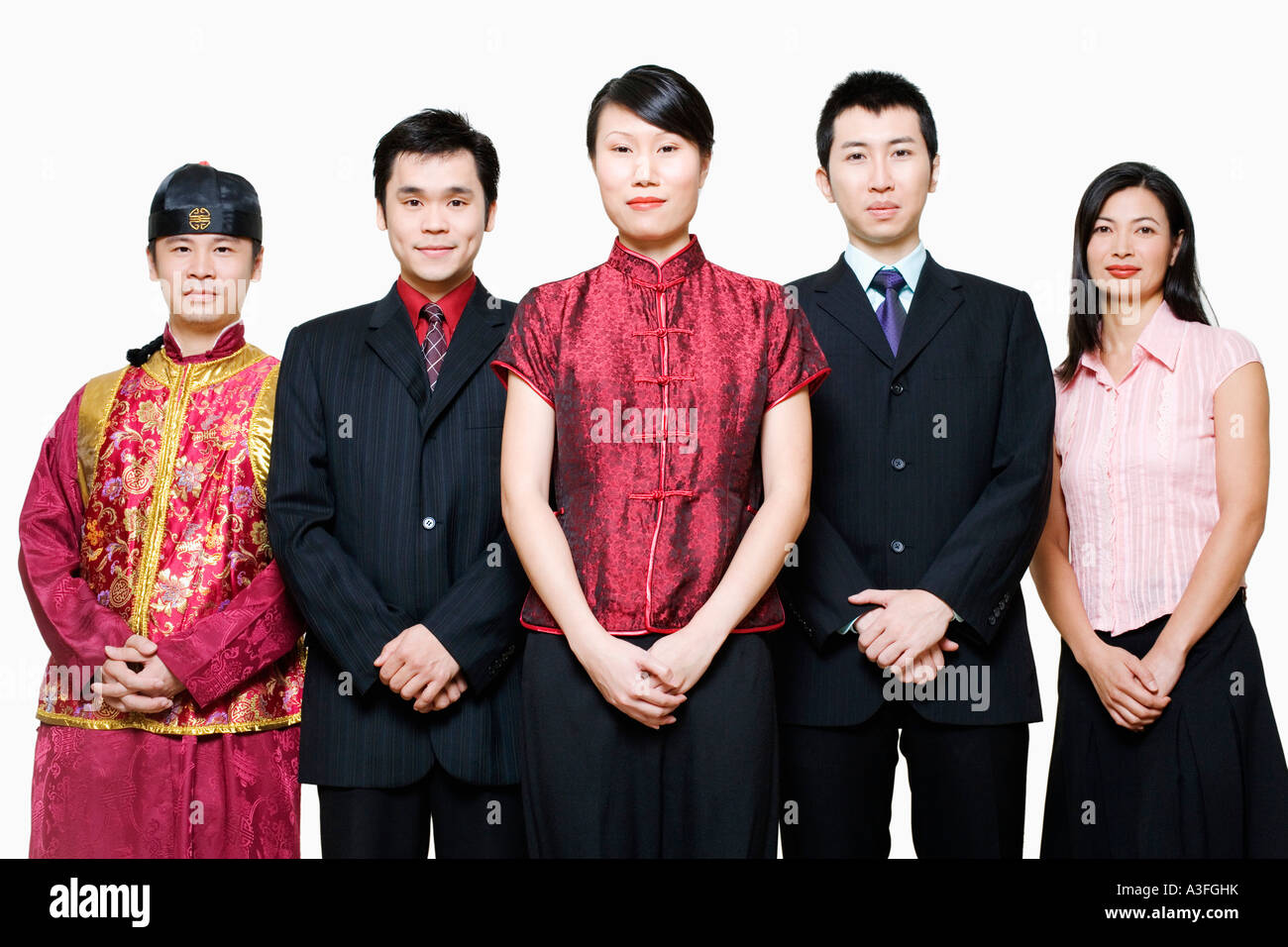 Portrait of four business executives and a young man standing together ...