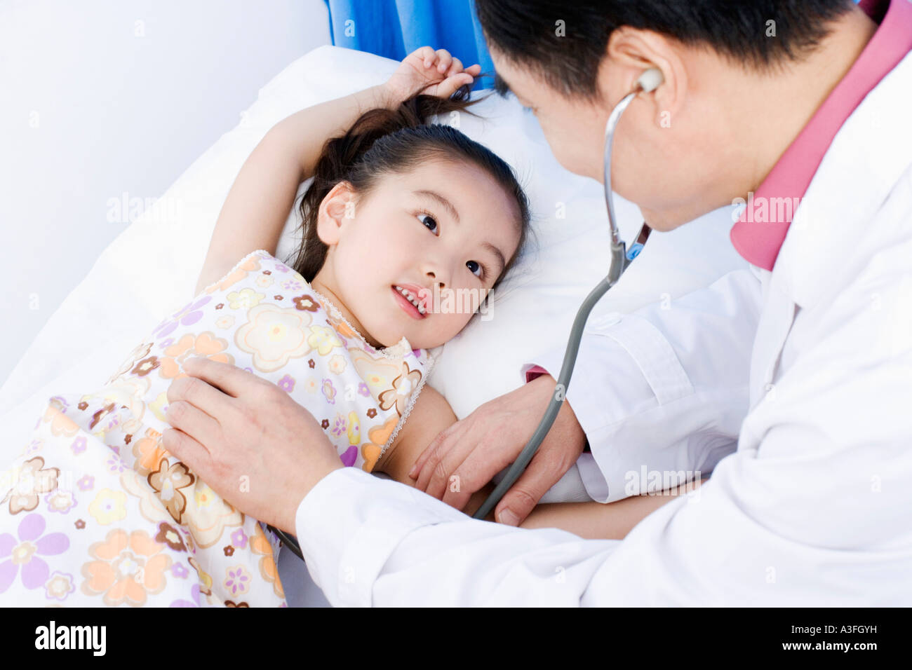 Close-up of a girl being examined by a male doctor Stock Photo