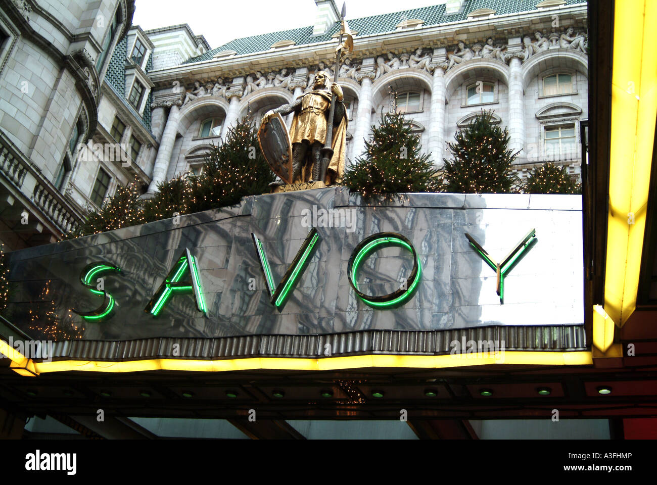 Christmas trees decorating the Savoy Hotel entrance Strand London Stock