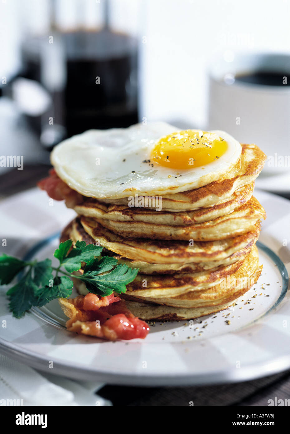 Individual portion american pancake stack fried egg hires stock