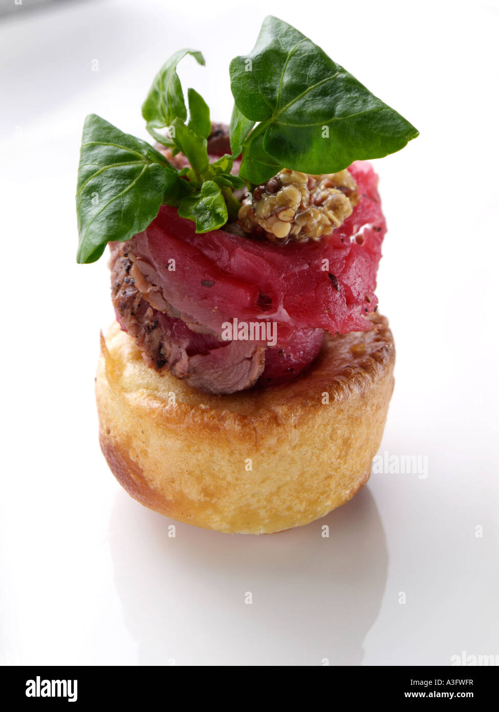 Beef and Yorkshire Pudding canape on a white background editorial food