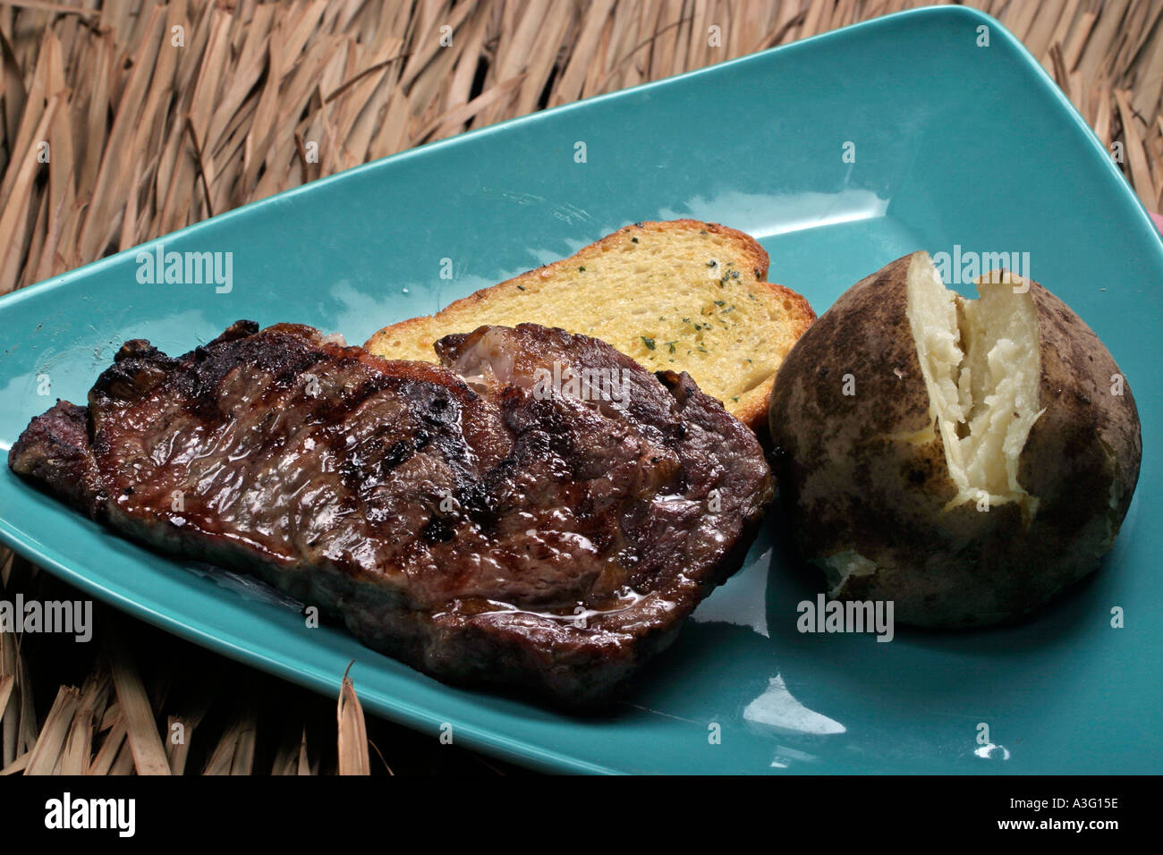 Steak potato blue plate special garlic bread Stock Photo