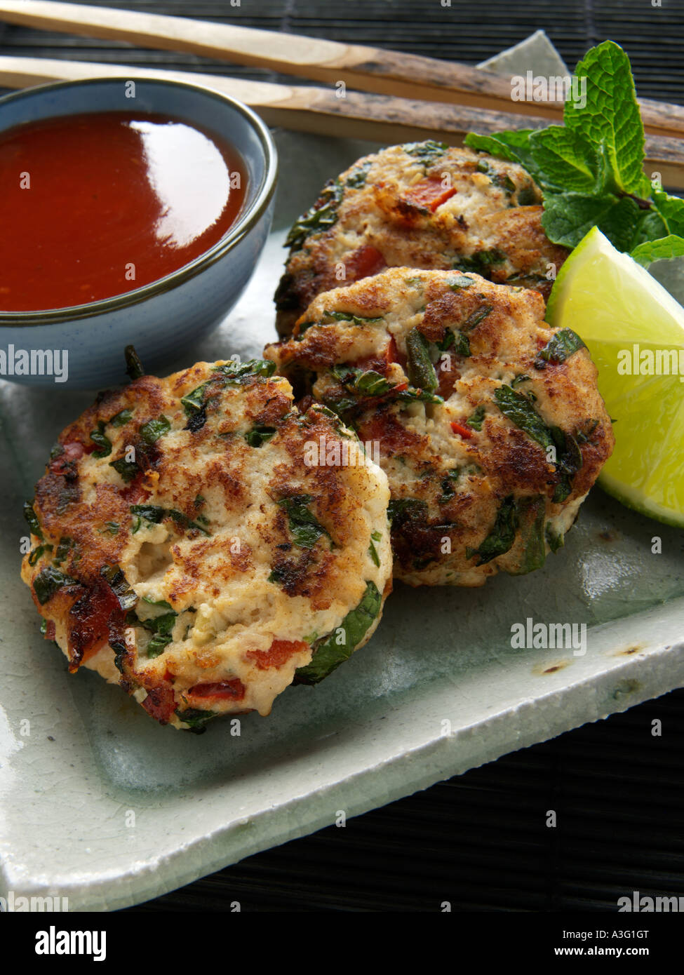 Homemade spicy fried thai fish cakes dipping sauce hi-res stock