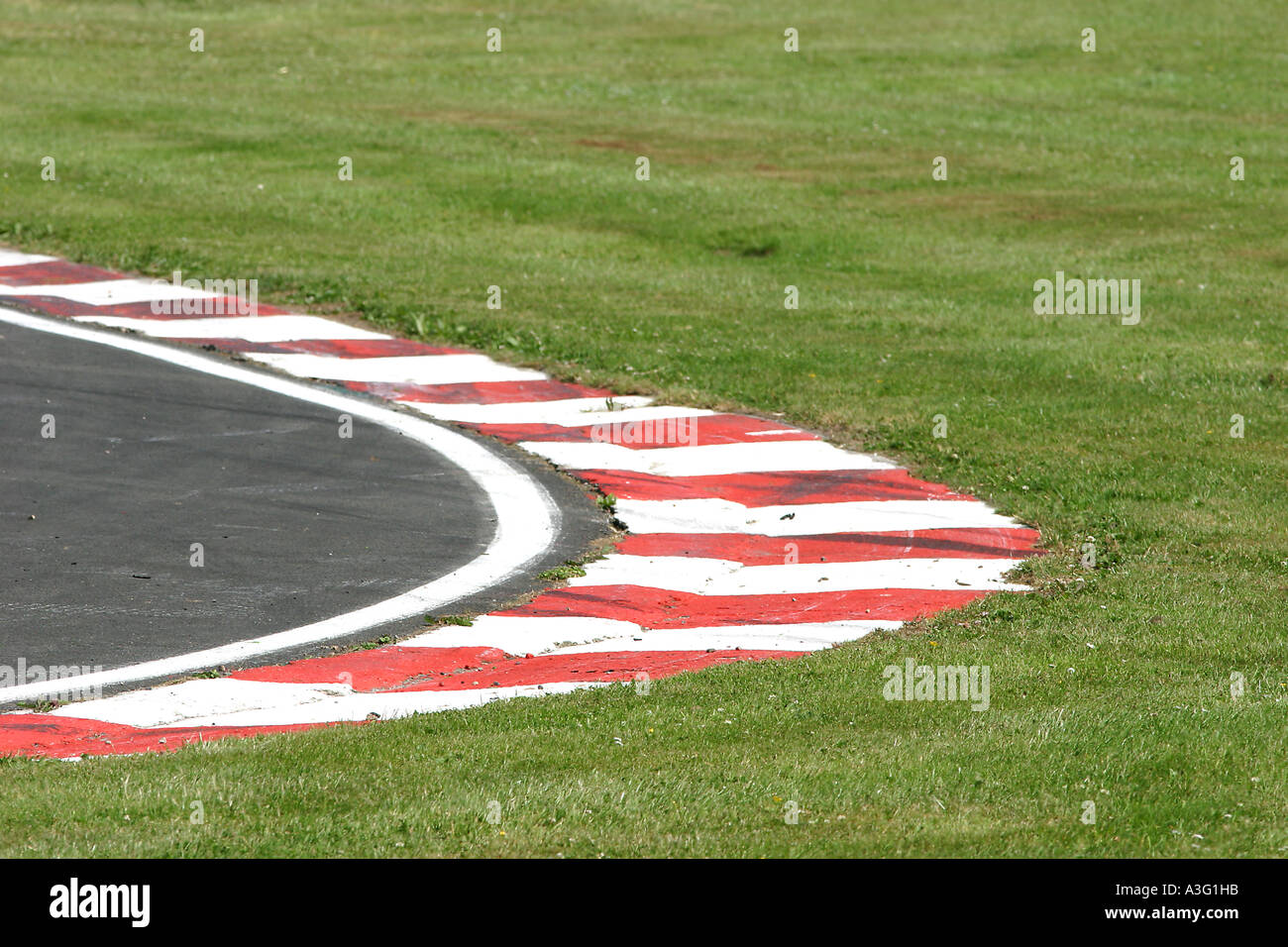 photograph of a race circuit corner with red and white markings Stock
