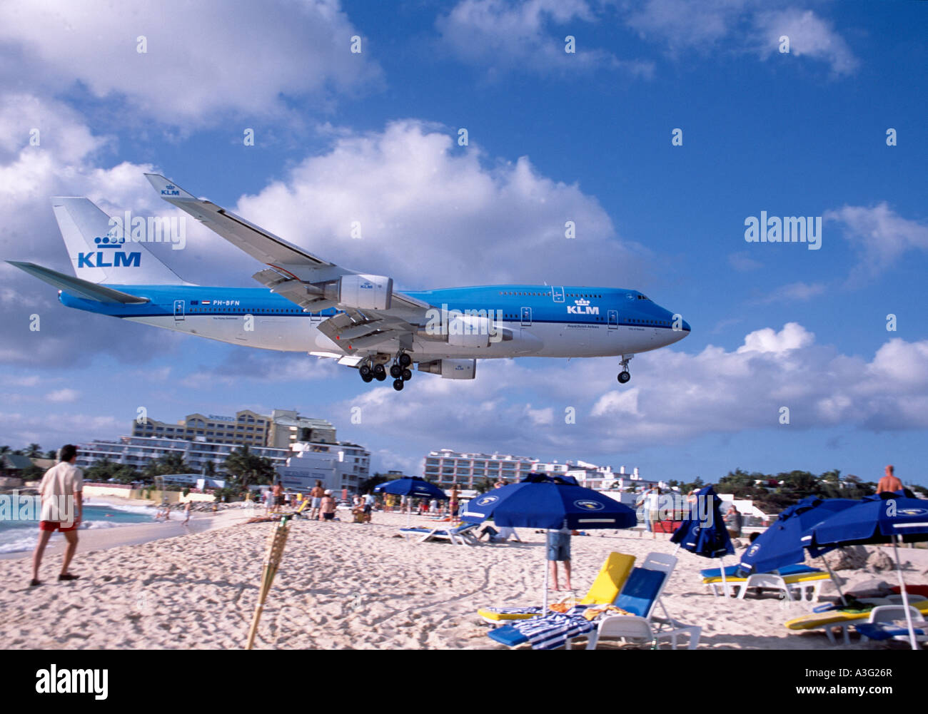 KLM Boeing 747 landing over white tropical sand beach at Princess