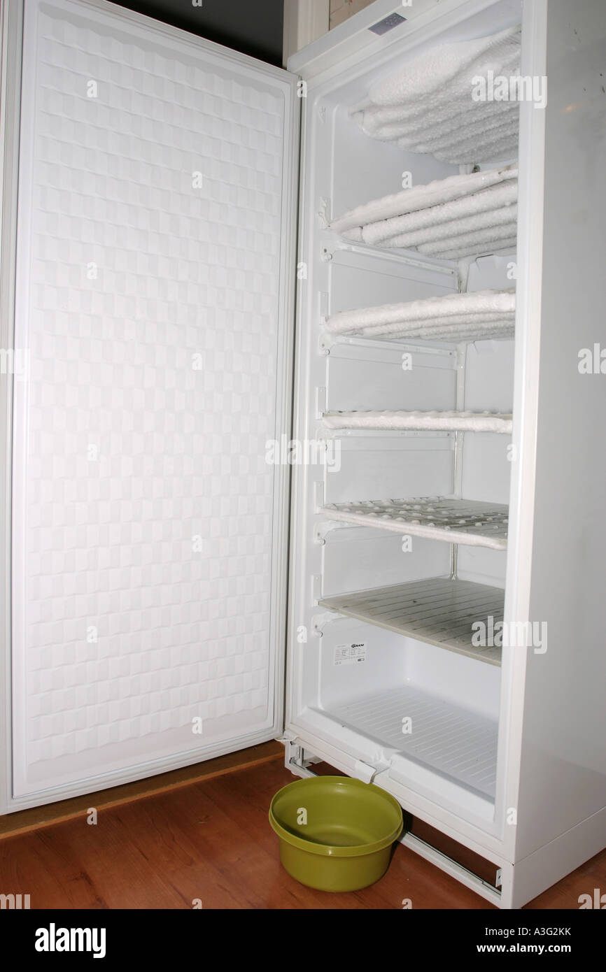 Defrosting a freezer full of ice Stock Photo Alamy
