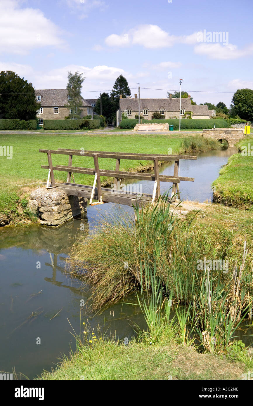 Stream running through the village green at the Cotswold village of Bledington, Gloucestershire Stock Photo