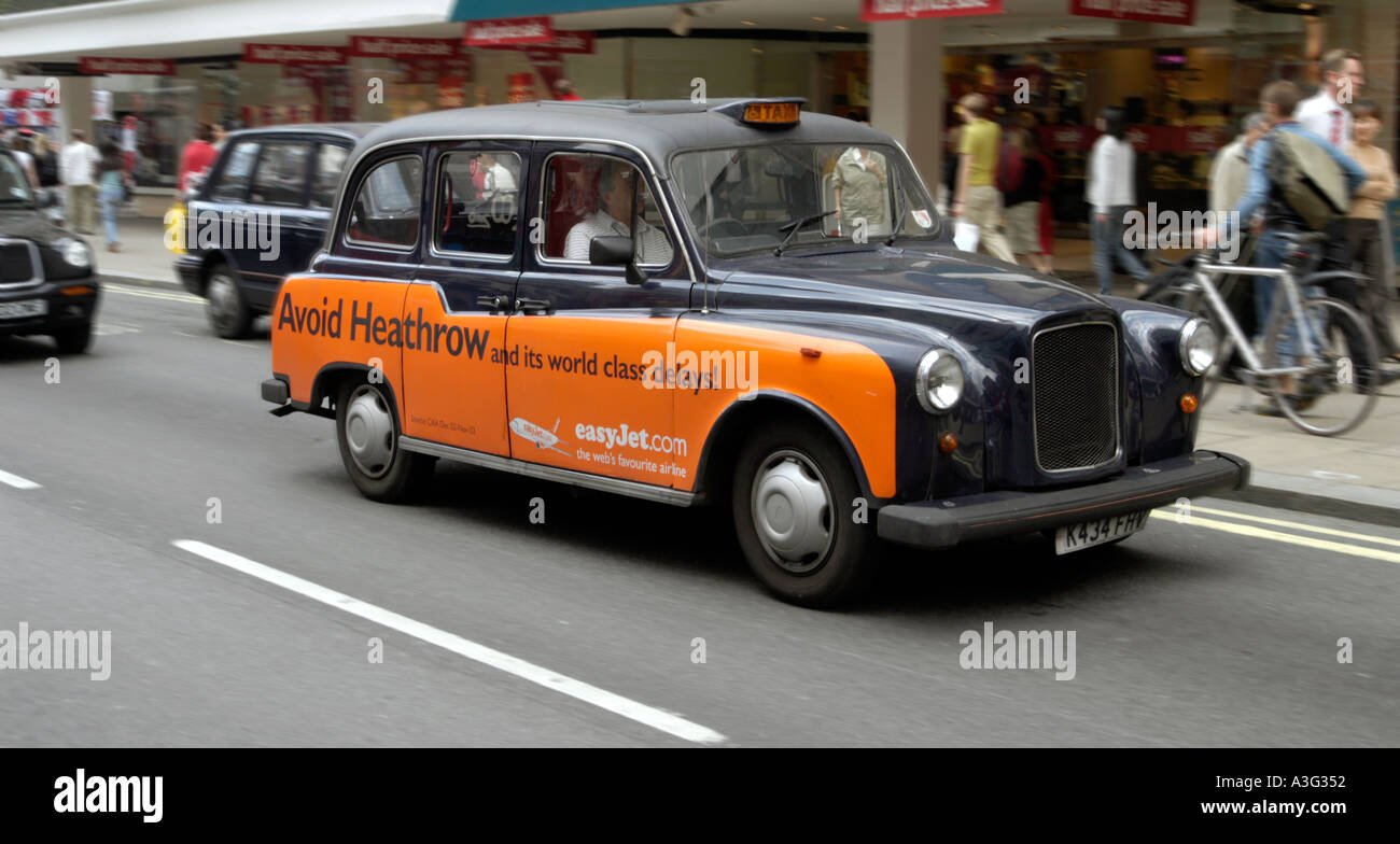 Traditional black hackney cab in Londons Oxford Street Stock Photo Alamy