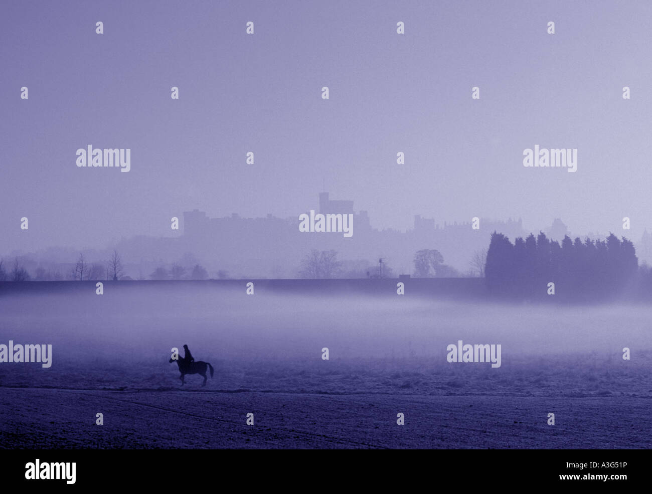 rider and horse with outline of Windsor castle in background england Stock Photo