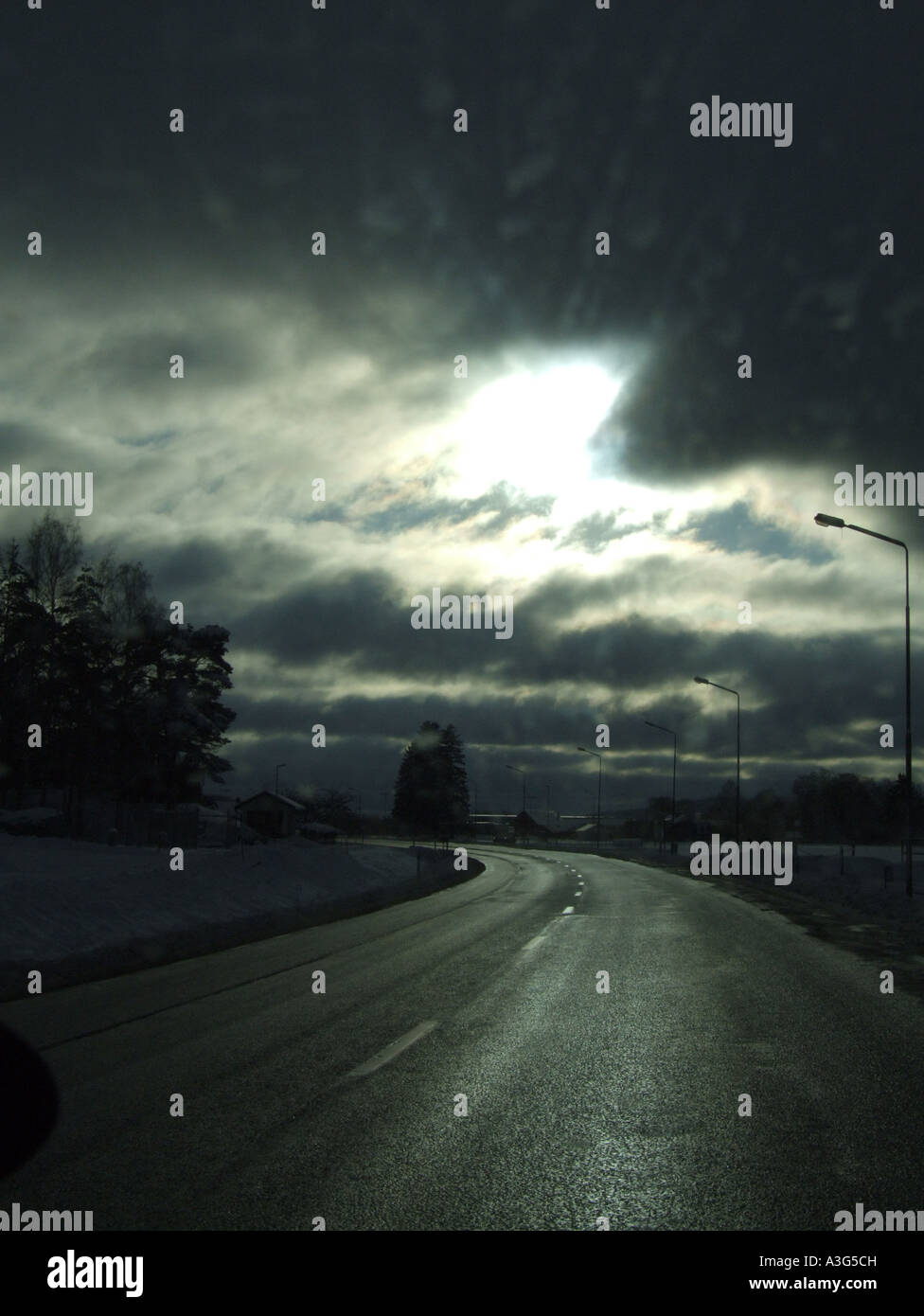 quiet road with stormy sky Stock Photo - Alamy