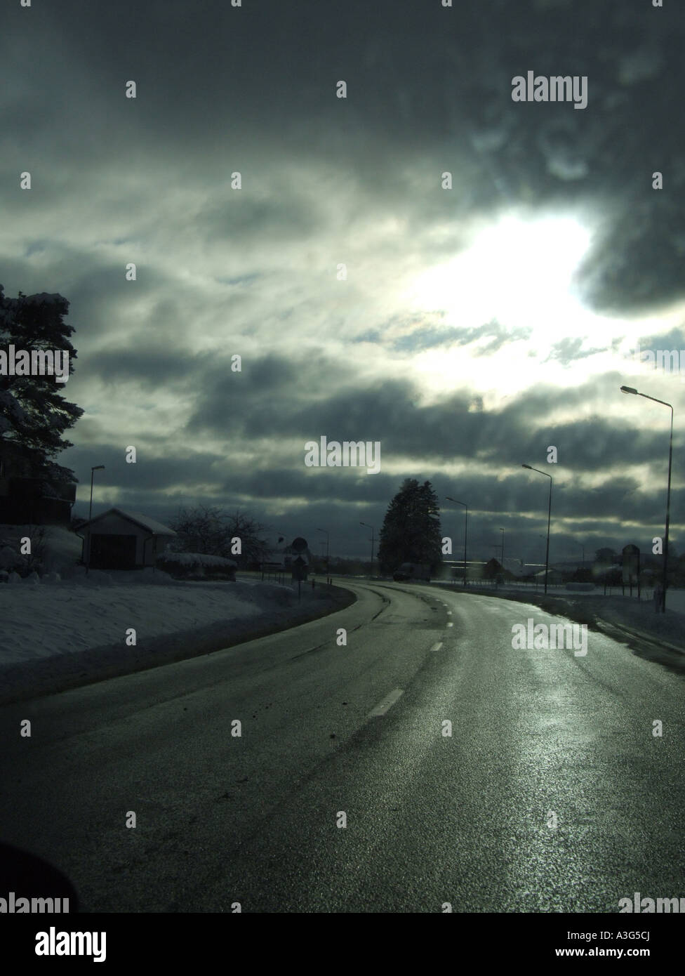 quiet road with stormy sky Stock Photo - Alamy