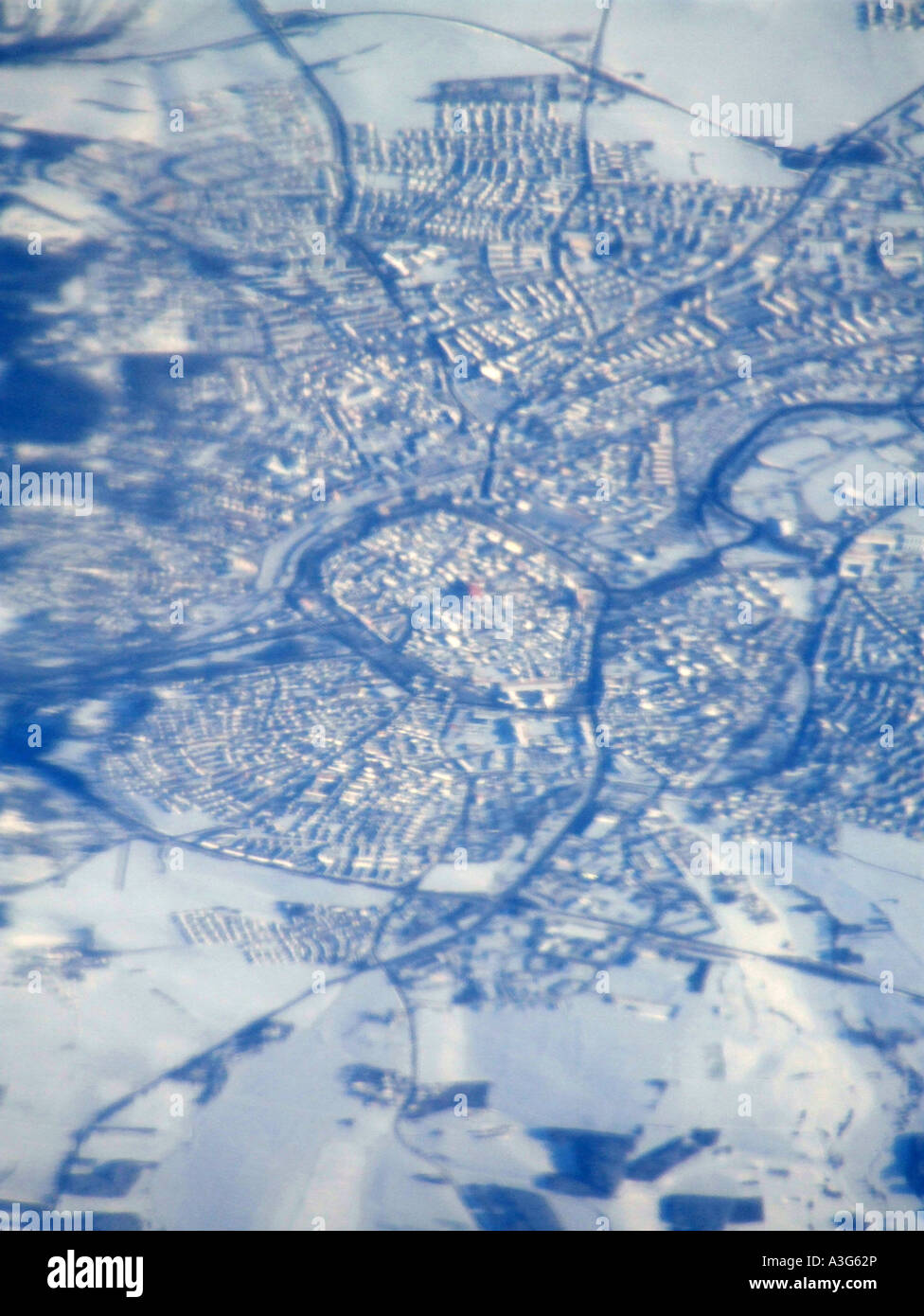 aerial view of a city under snow seen from plane window Stock Photo - Alamy