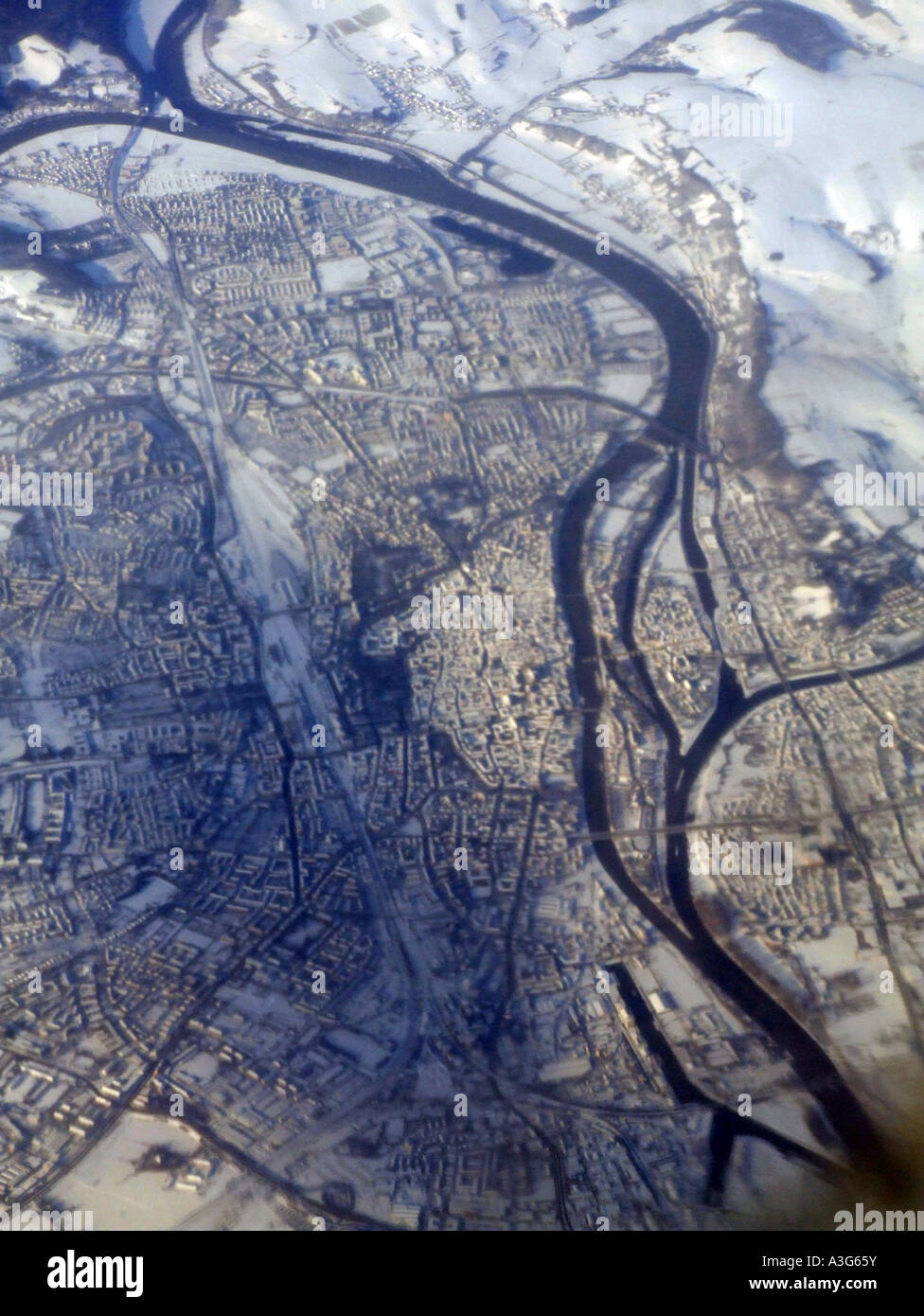 aerial view of a city under snow seen from plane window Stock Photo - Alamy