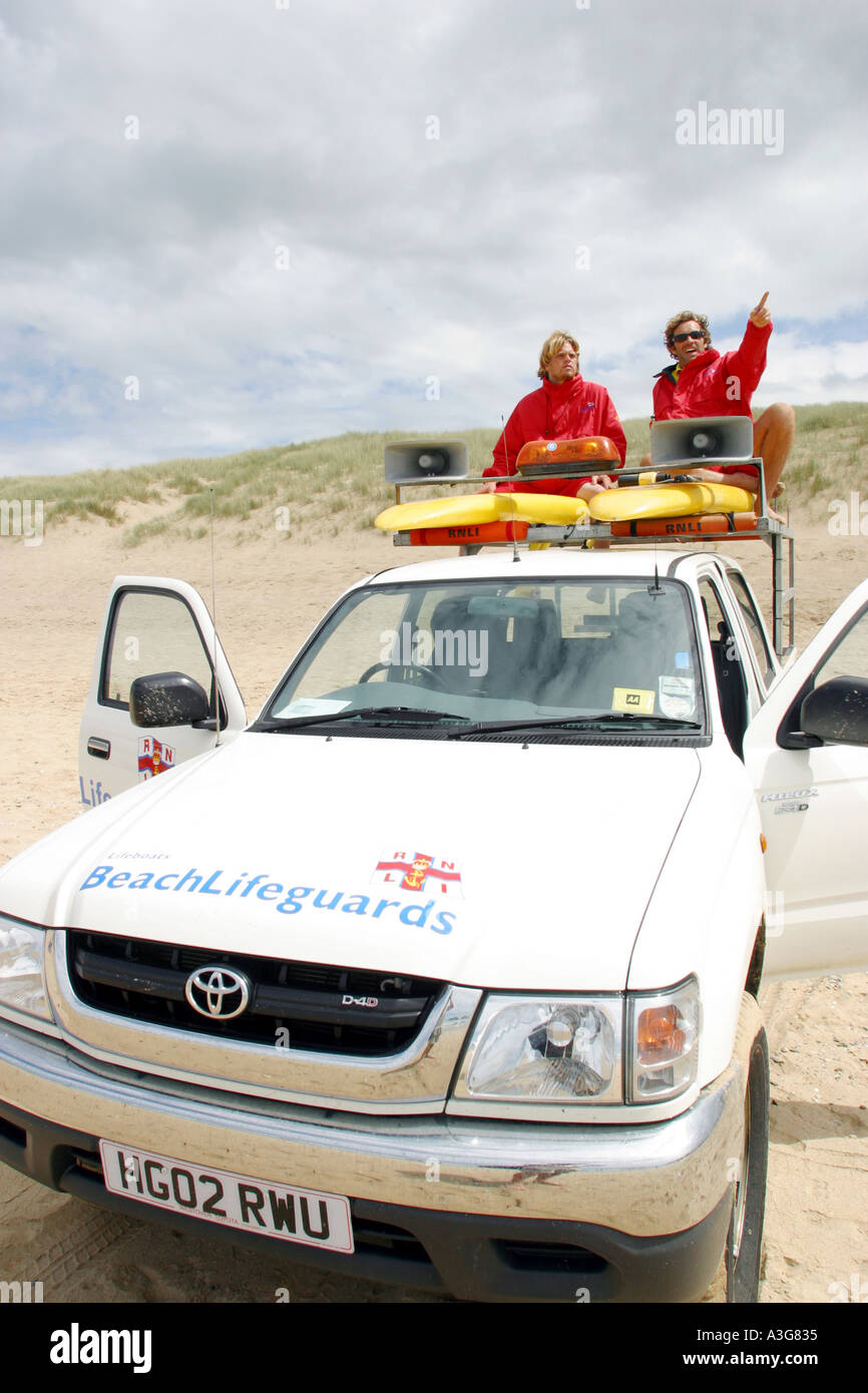 RNLI Beach Lifeguards on patrol at Holywell bay Cornwall UK Stock Photo