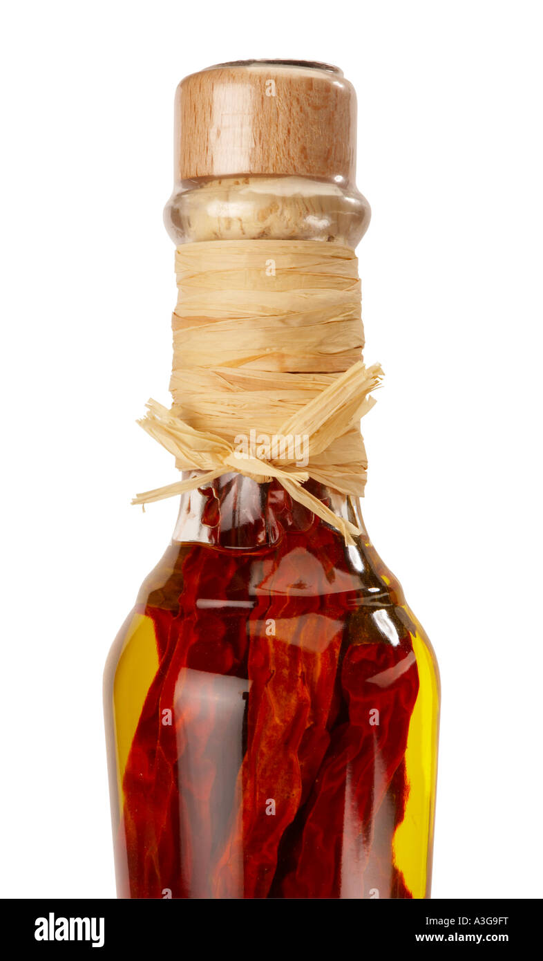CLOSE UP BOTTLE OF OLIVE OIL WITH RED CHILLIS Stock Photo