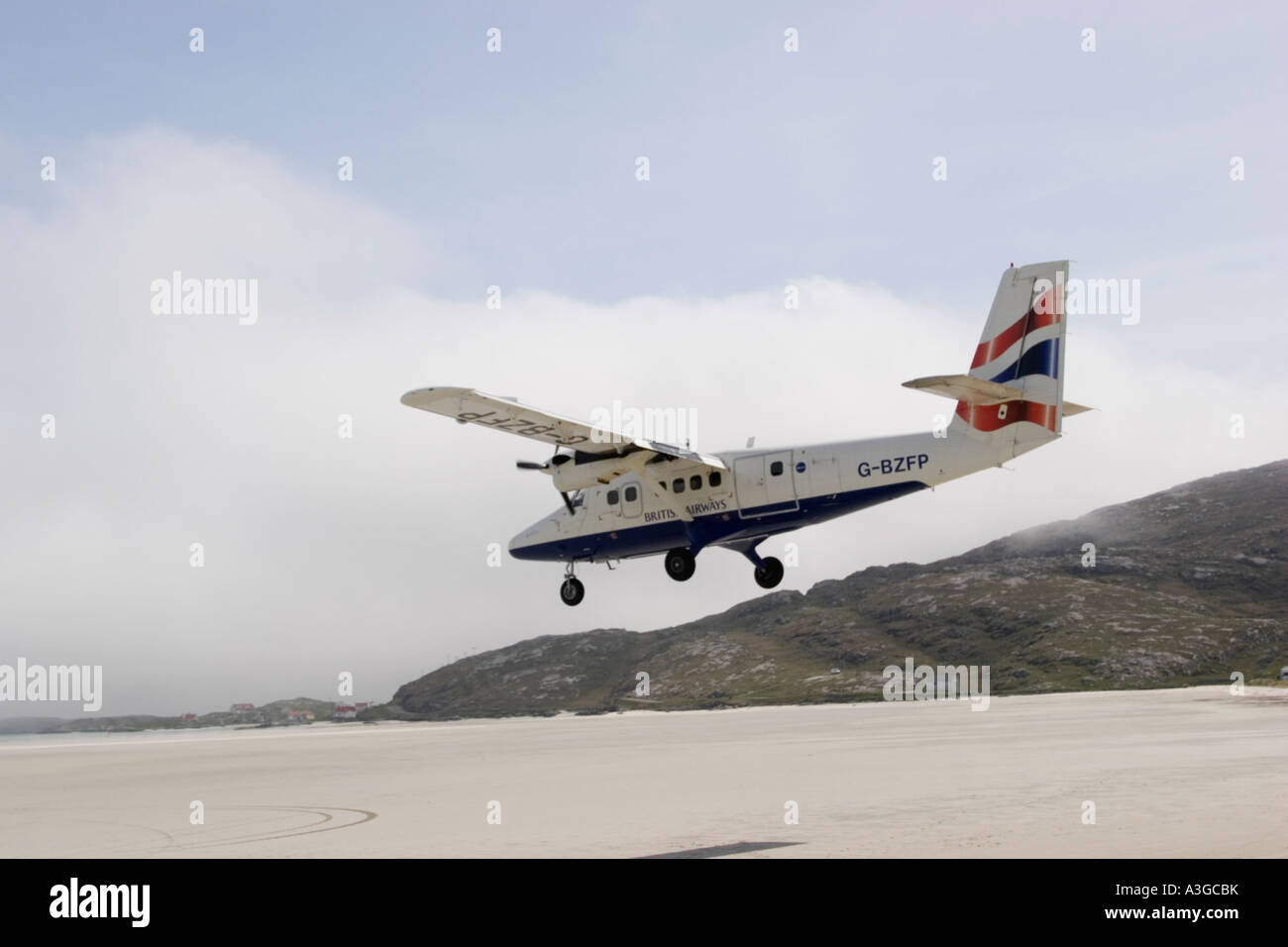 british scotland outer hebrides island of barra barra airport with a twin otter landing plane on sand Stock Photo