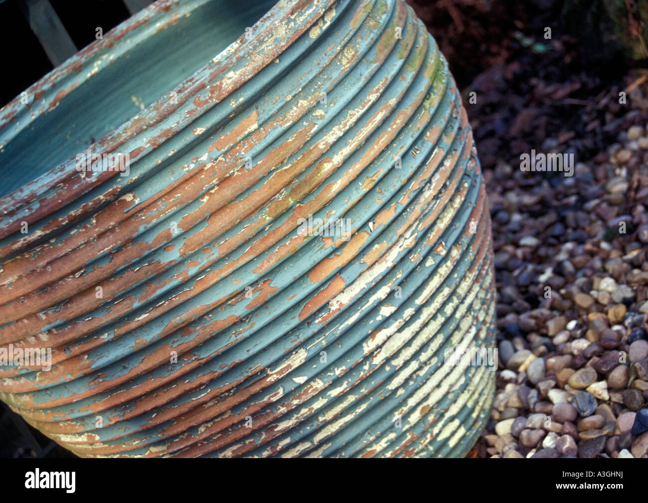 Terracotta plant pot sitting on gravel path Stock Photo