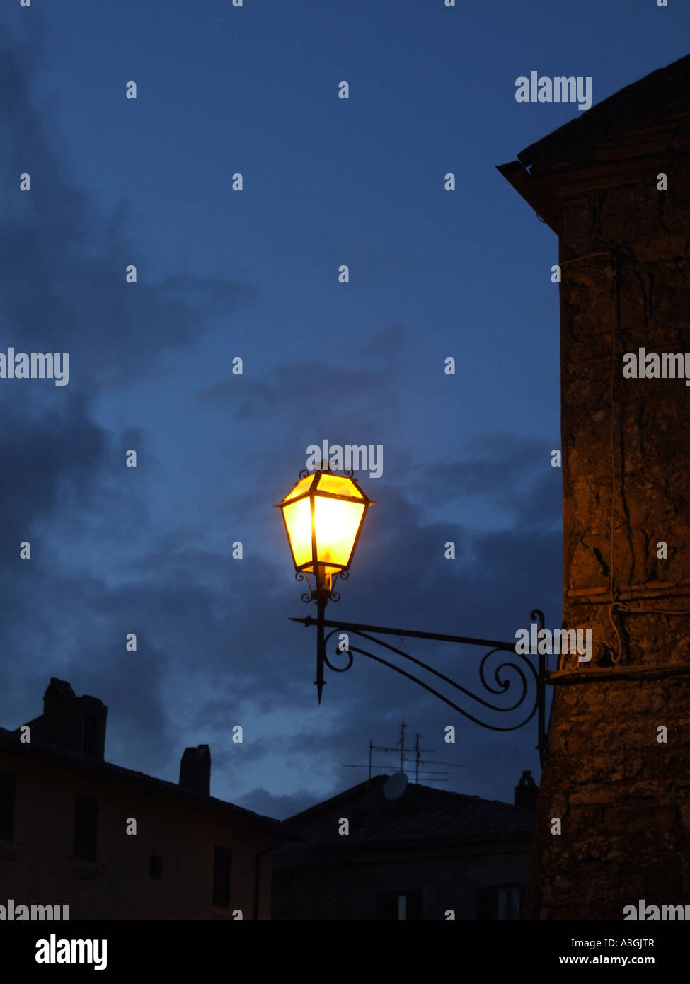 lit street lamp in italian village at night Stock Photo Alamy