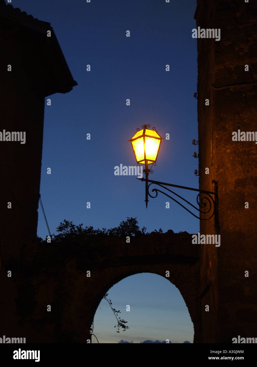 lit street lamp in italian village at night Stock Photo Alamy