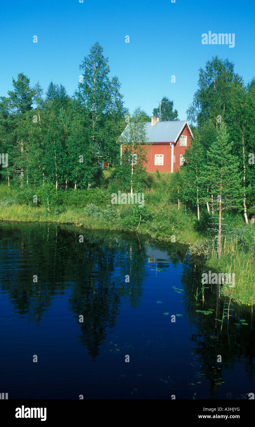 typical red wooden house at a lake in Central Sweden Stock Photo