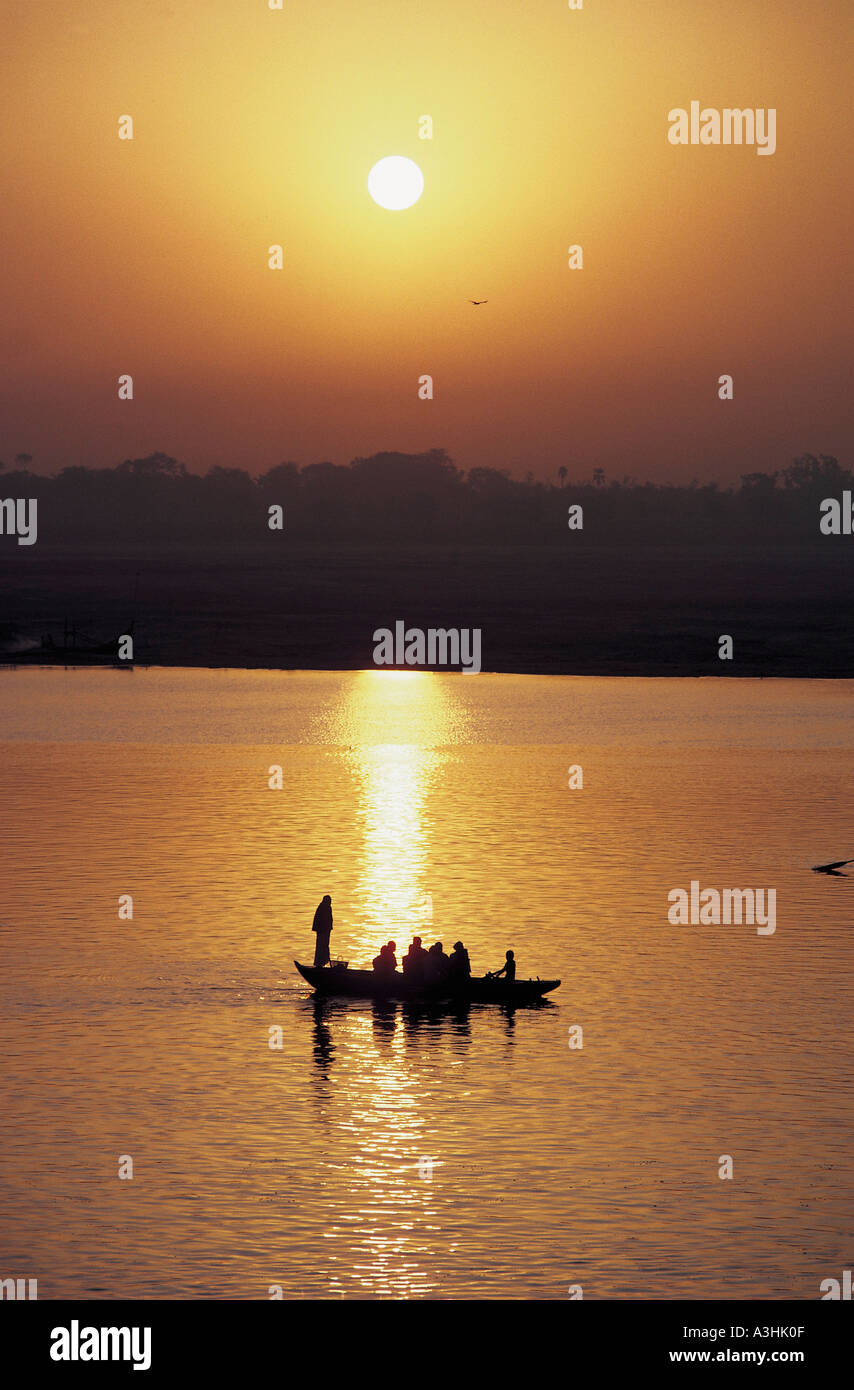ferryboat acrossing ganga river at sunset near city of varanasi state of uttar pradesh india Stock Photo